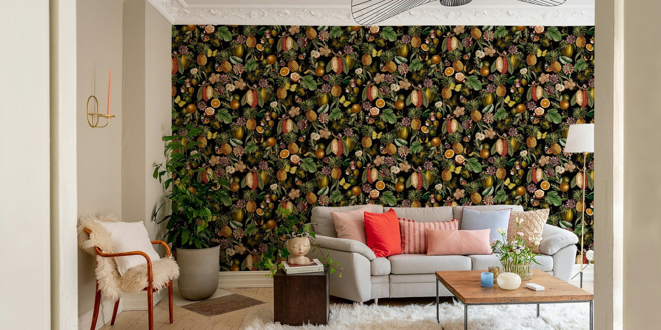 Lush green leaves and vibrant tropical flowers on wallpaper.

