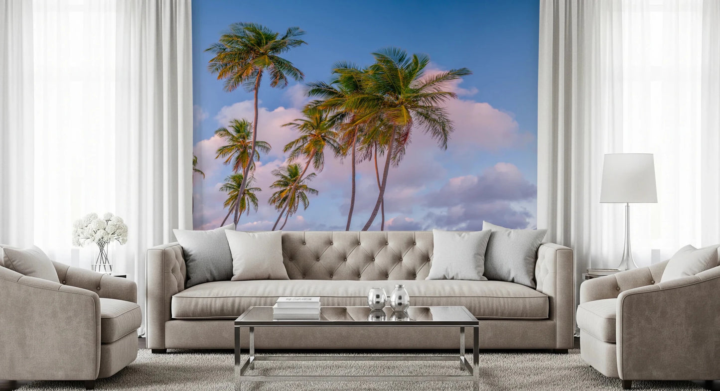 Cozy living room framed by Tropical Palms Evening Wall Mural in blush and blue tones