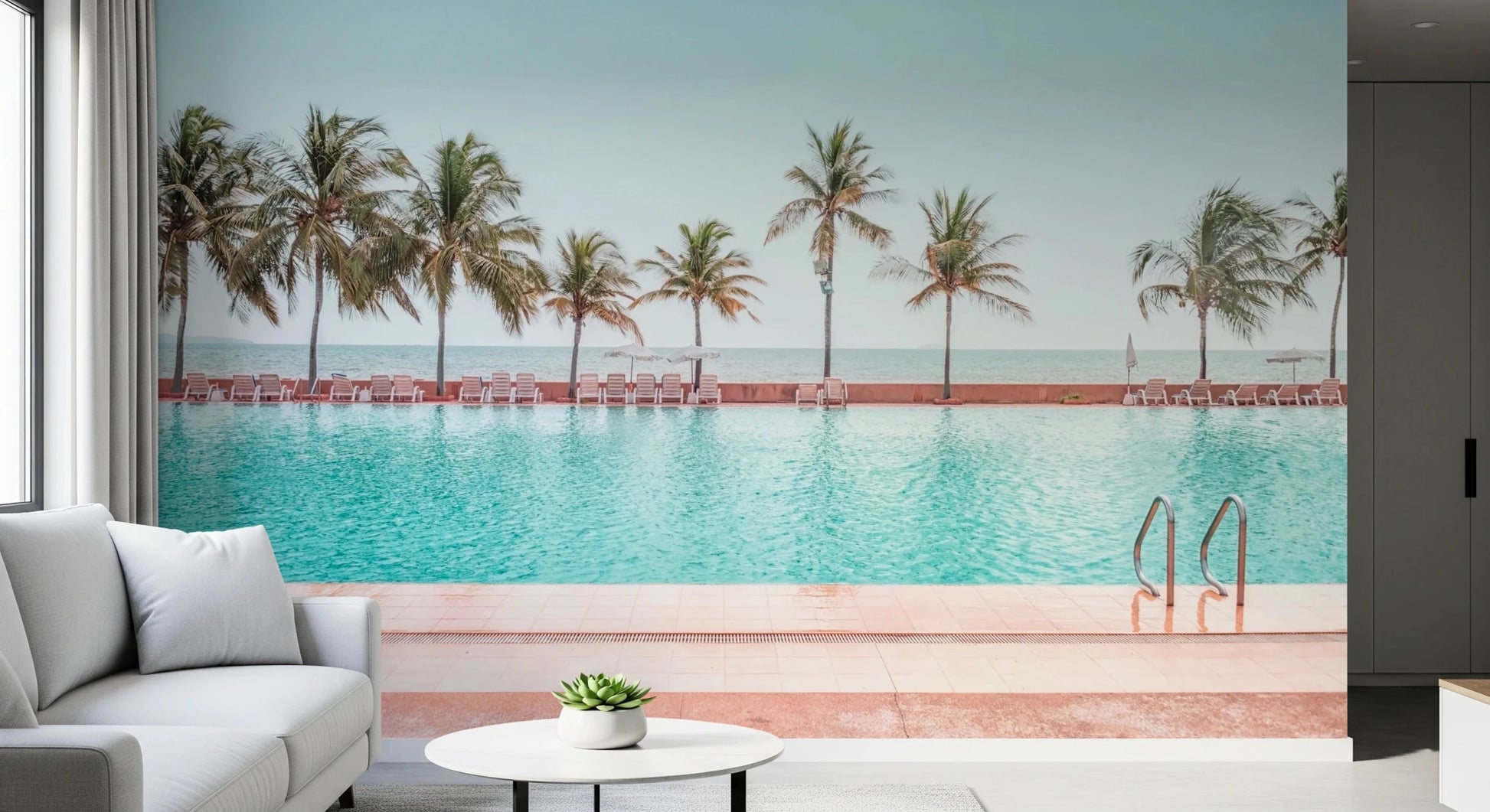 Calm coastal landscape wall mural showing a row of tall palms by the water.