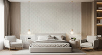 Living interior softened by Tulip Cream Wallpaper behind layered bedding