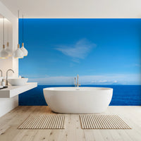 Modern bathroom with Turquoise Blue Sea Wall Mural behind a freestanding white bathtub, GD8863