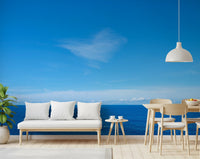 Open-plan living and dining area with Turquoise Blue Sea Wall Mural behind a white sofa, GD8863