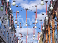 Urban Hanging Lights Wall Mural with suspended bulbs between tall city buildings, GD8870