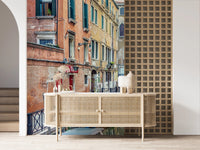 Venetian gondola floating on calm canal water mural.