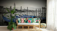 Scenic waterway wallpaper with traditional wooden boats and gothic style windows.