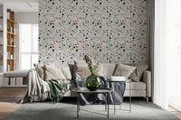 Shards of various colors fill the vibrant multicolour terrazzo speckled wallpaper surface.