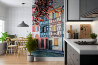 Vintage Alsace Wall Mural adds storybook street charm beside a modern kitchen