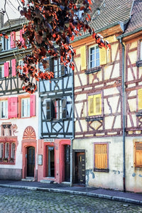 Vintage Alsace wall mural with pastel shutters and timber-front street facade view