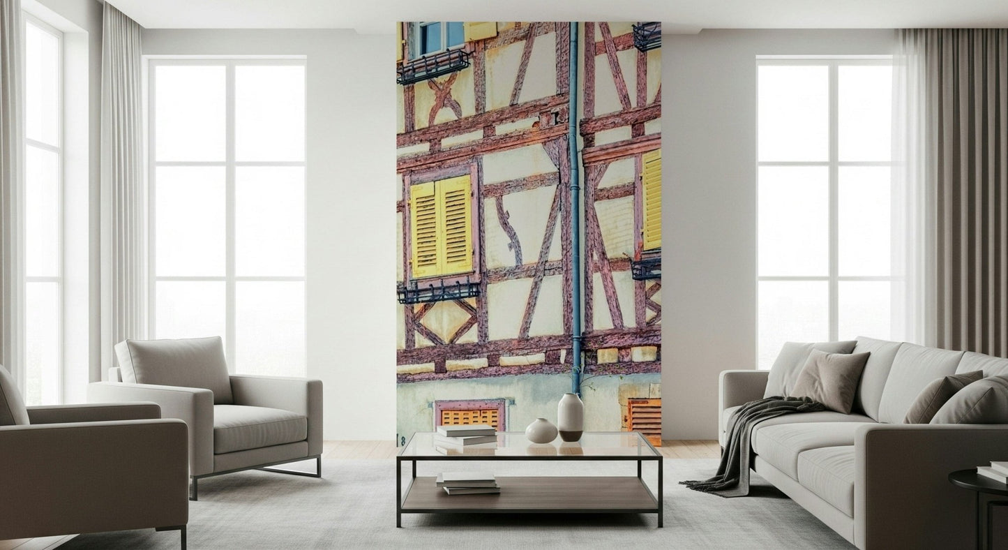 Vintage Alsace Wall Mural softens a living room with pastel shutters and beams