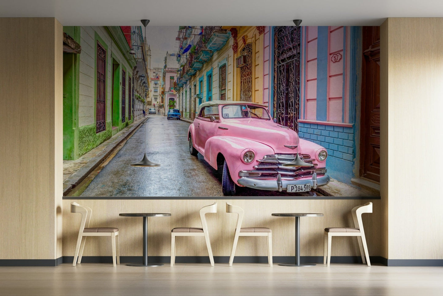 Old-school car mural on a sunlit Cuban street.

