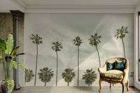 Faded mural showing classic palm silhouettes in warm tones.

