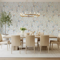 Dining room with blue monkey and sakura wallpaper and brass chandelier