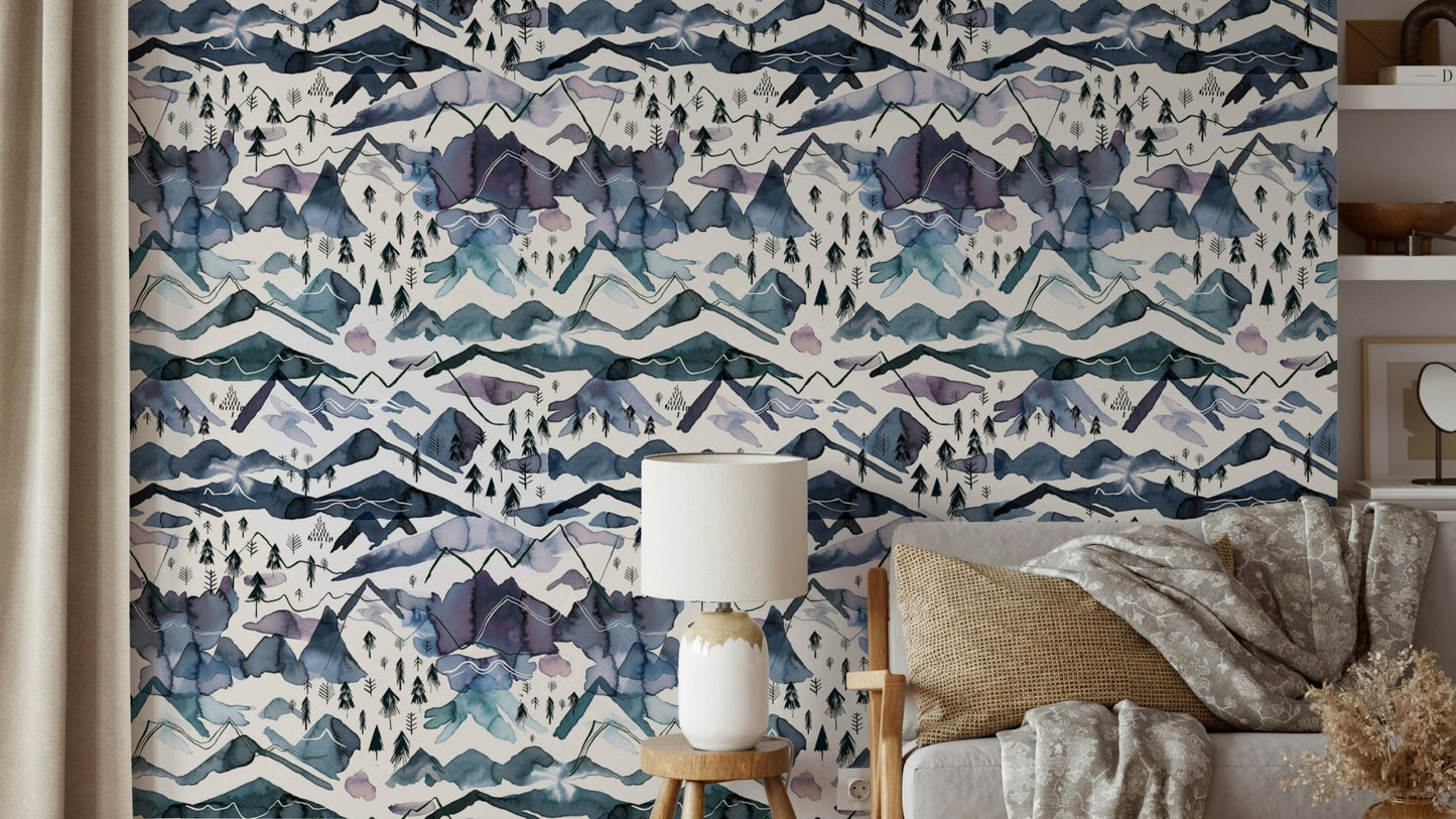 Dreamy watercolor mountain wallpaper in blue and mauve tones.

