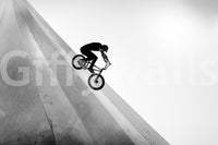 BMX rider on steep concrete wall

