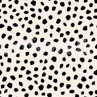 A seamless pattern of irregular black spots on a wall

