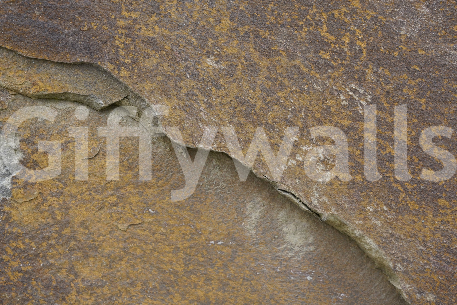 Angled view of the Cracked Stone earthy wallpaper.