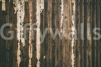 Rustic texture of the Weathered Wood peel and stick mural behind a fireplace.