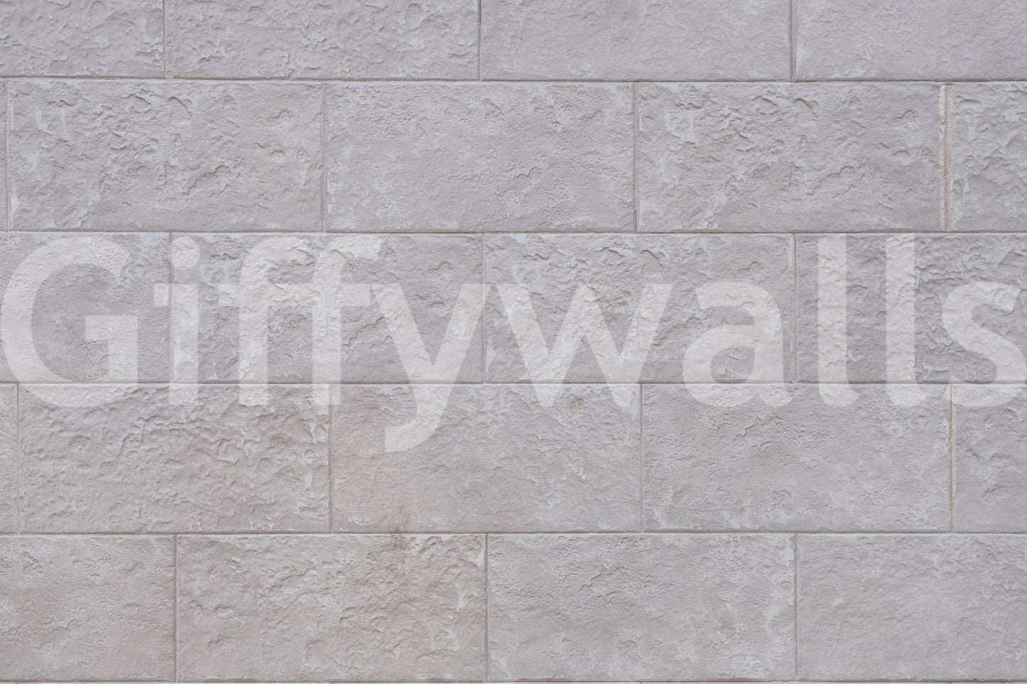 Luxurious feel of the Elegant Stone Blocks peel and stick mural behind a fireplace.