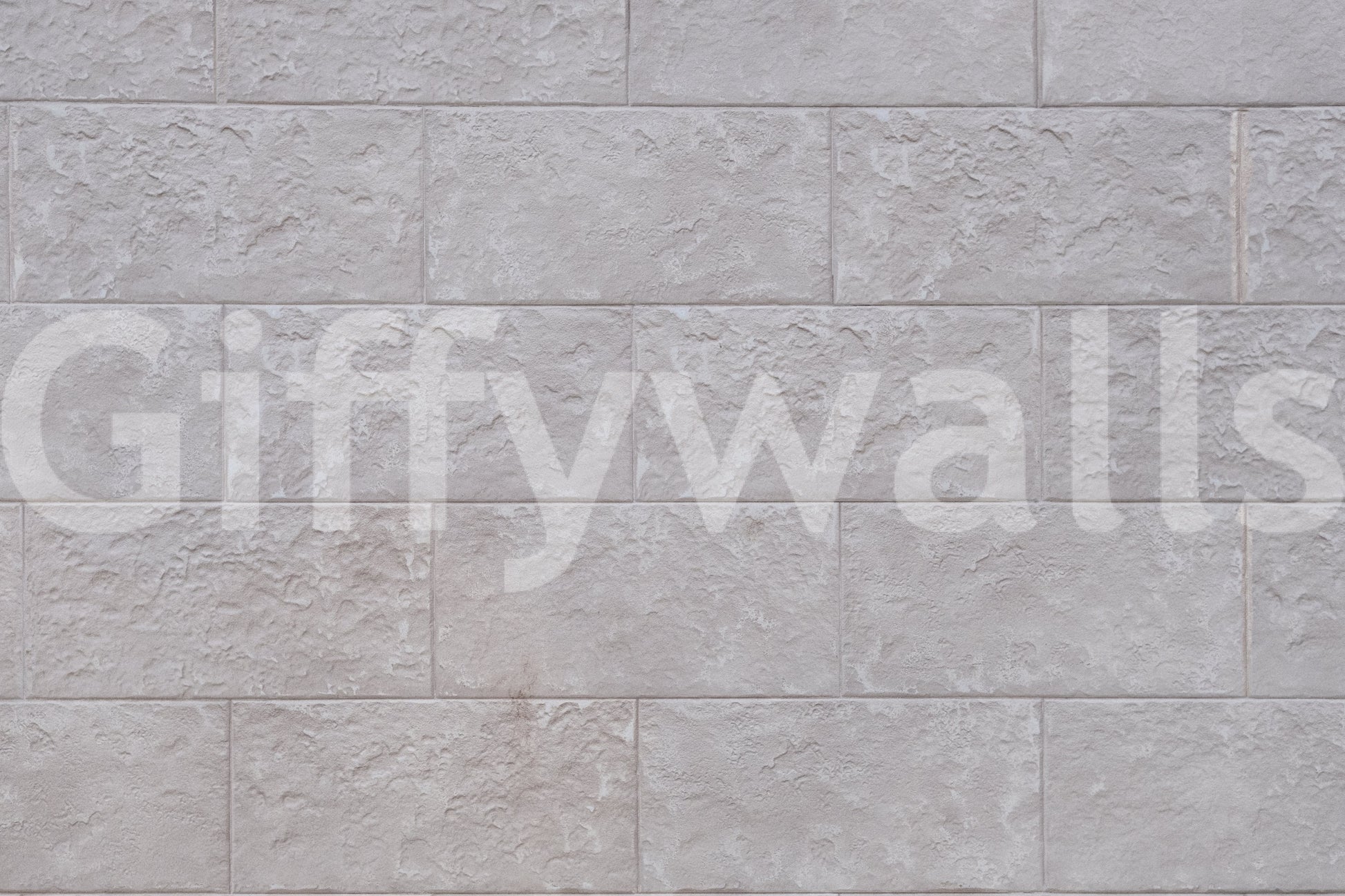 Luxurious feel of the Elegant Stone Blocks peel and stick mural behind a fireplace.