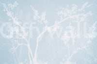 Blue and white blossom silhouette wall mural with layered branch structures