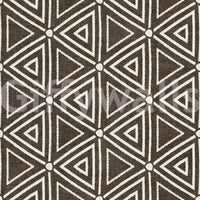 Mudcloth-style nested triangles laid on umber wallpaper in cream and brown