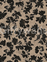 Black floral silhouette wall mural on warm beige distressed surface.