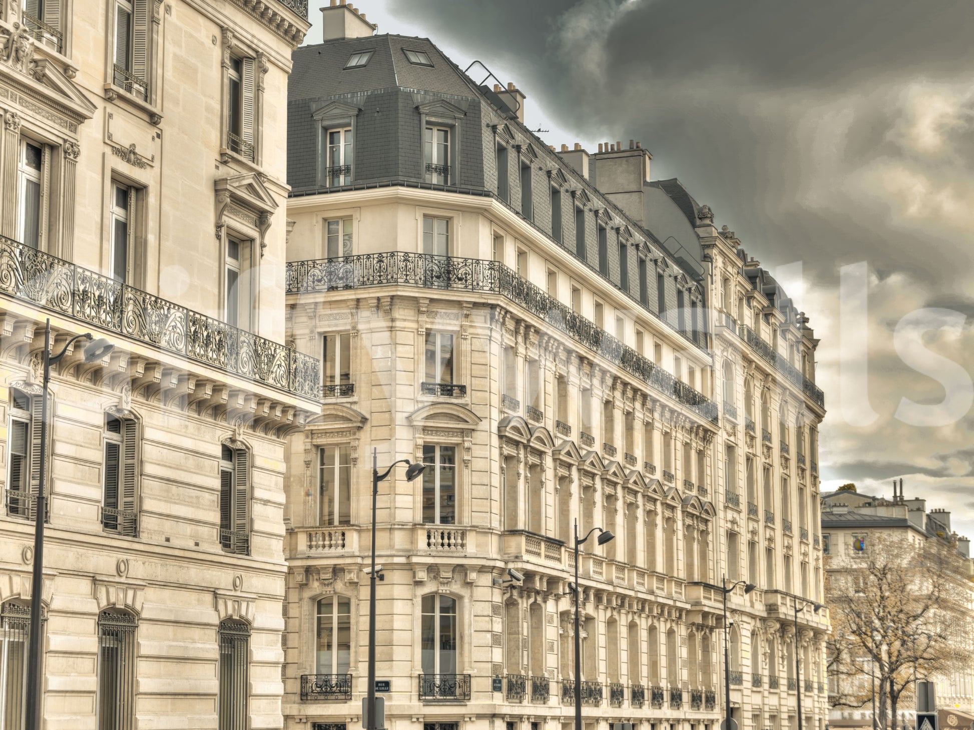 Parisian Facades & Dramatic Skies Wall Mural with grey clouds and stone details.