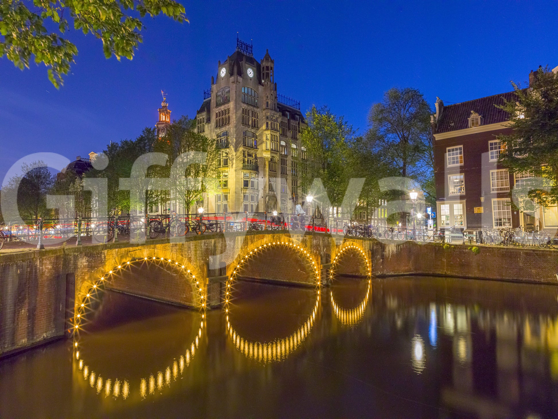 Deep cobalt blue evening tone of canal through Amsterdam city wall mural., GD10420
