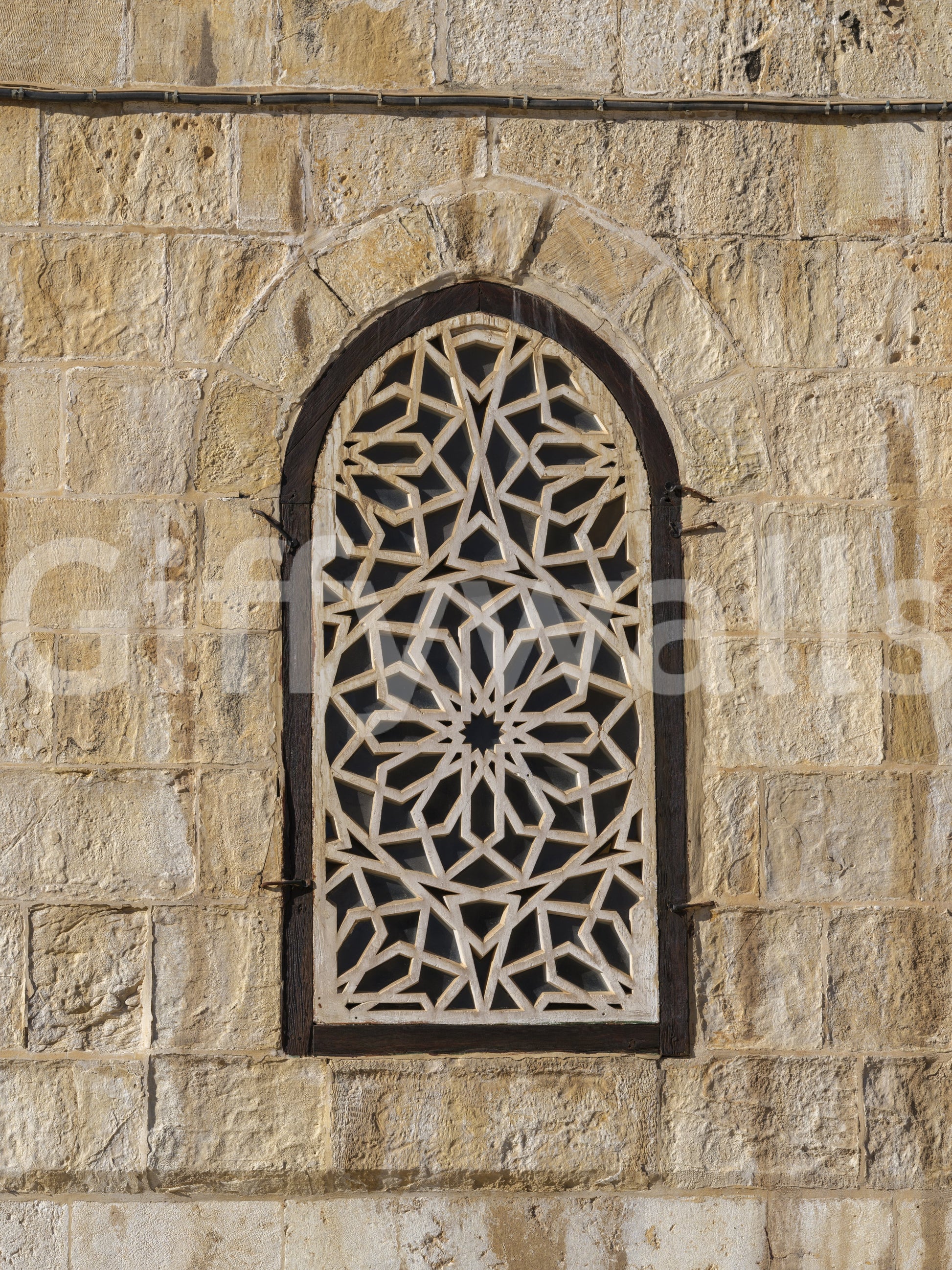 Beige sandstone texture with geometric lattice detail in Moorish wall mural., GD10440
