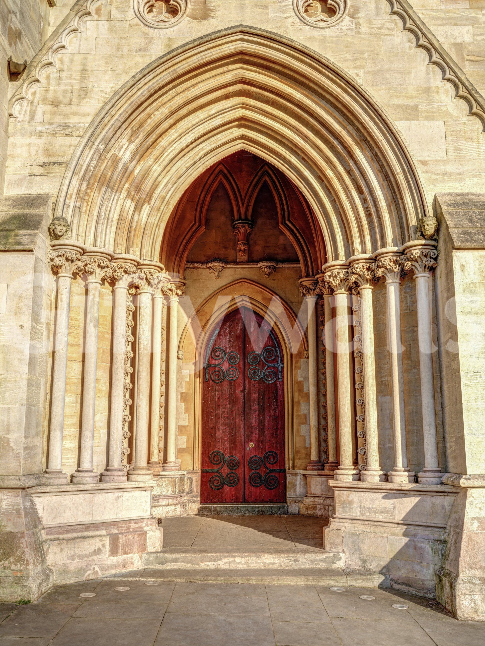 Gothic entryway wall mural with sandstone arch and red door tones., GD10451