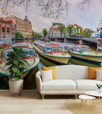 A peaceful wall mural with a view of a canal in Amsterdam.


