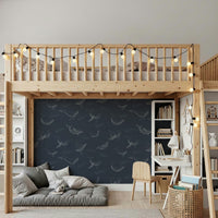 Whale Song Serenade Wall Mural displayed behind a grey fabric sofa.