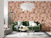 Green sofa nook brought to life with exotic garden pink wallpaper and leafy branches