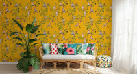 Sunlit corner of a living space with Monkeys Vineyard Yellow wallpaper and plants.
