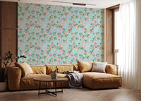 Warm lounge corner framed by whimsical garden party wallpaper on a pale blue 