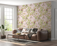 Vintage Garden Pink Wallpaper styled in a room with a brown leather sofa backdrop.