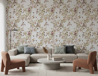 A soft living room styled with vineyard monkey wallpaper and warm neutral seating tones