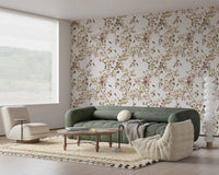 Comfortable seating zone featuring vineyard monkey wallpaper and soft botanical spread