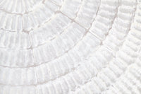 Corner view of a hallway brightened by the soft Whispered Texture wallpaper for walls.