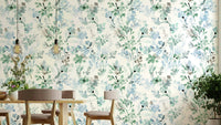 Delicate botanical wallpaper in sage and cream tones.

