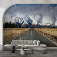 Winter's Road Wall Mural in a bright living room with white decor wallpaper.