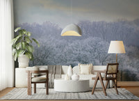 Frosty forest landscape wallpaper behind a wooden bed frame in a master bedroom.