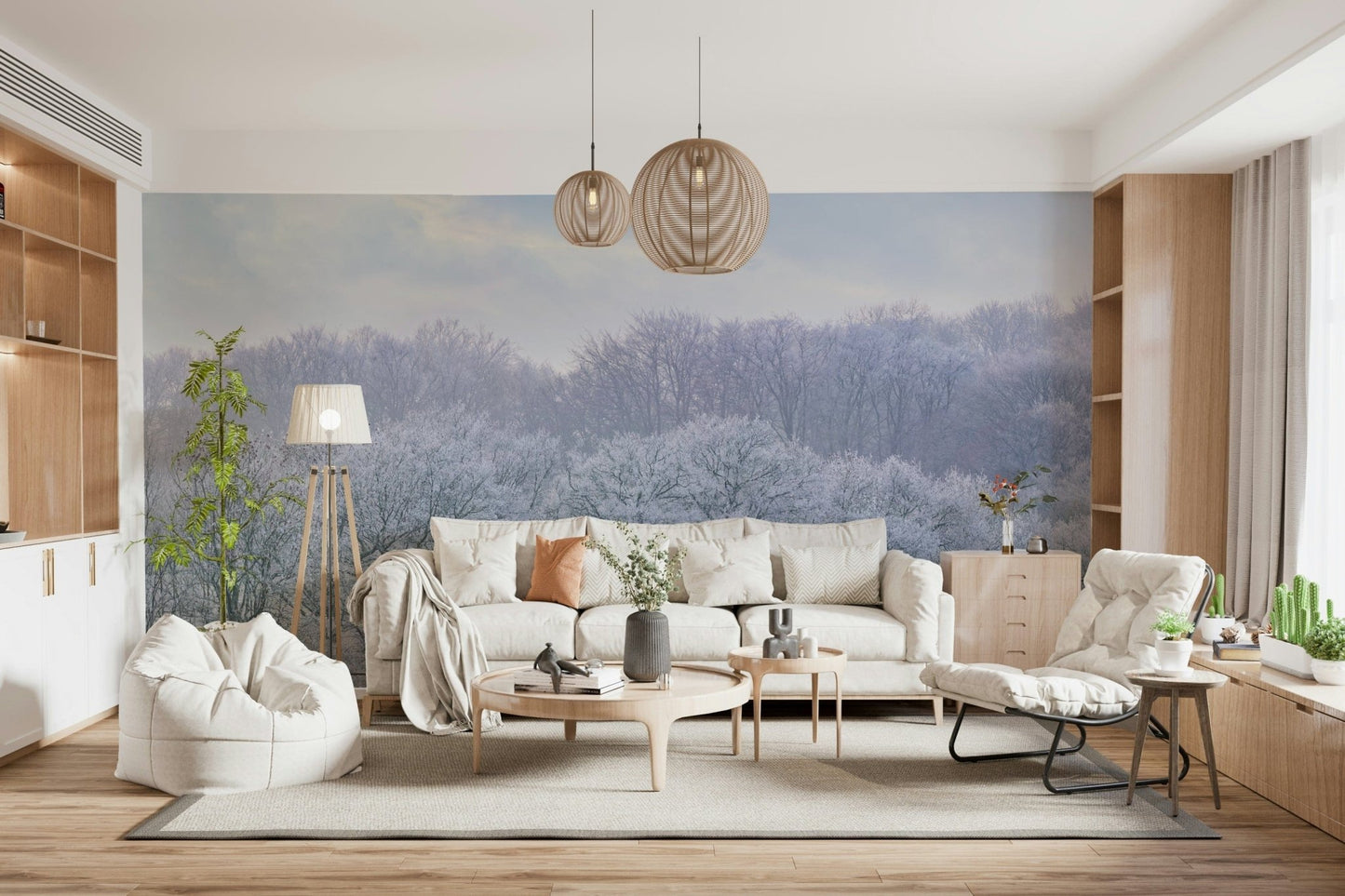 Muted grey and white forest scenery wallpaper on a large living room feature wall.