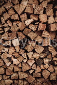 Rustic charm of the Woodpile Texture peel and stick mural behind a wood stove.