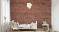 Bedroom wall behind headboard with rustic brick look.
