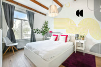 Close-up of yellow and gray geometric pattern mural

